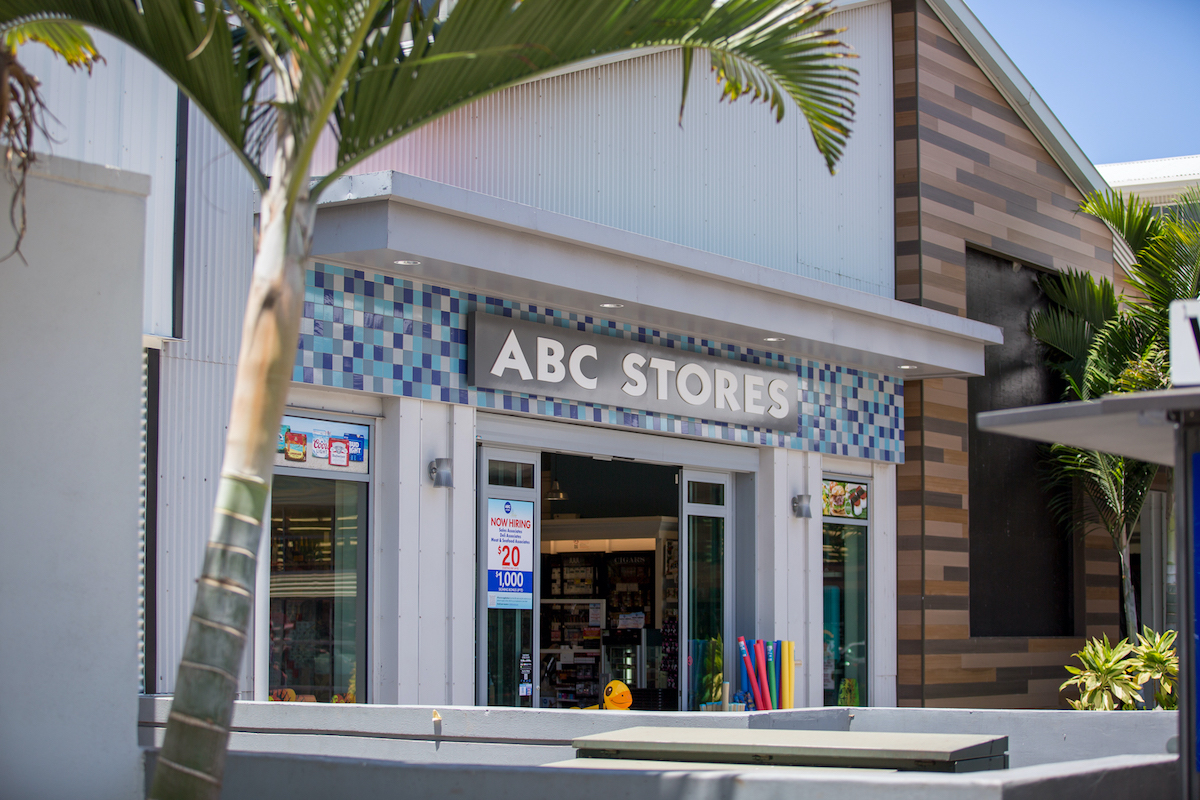 An ABC Stores storefront with a palm tree out front.