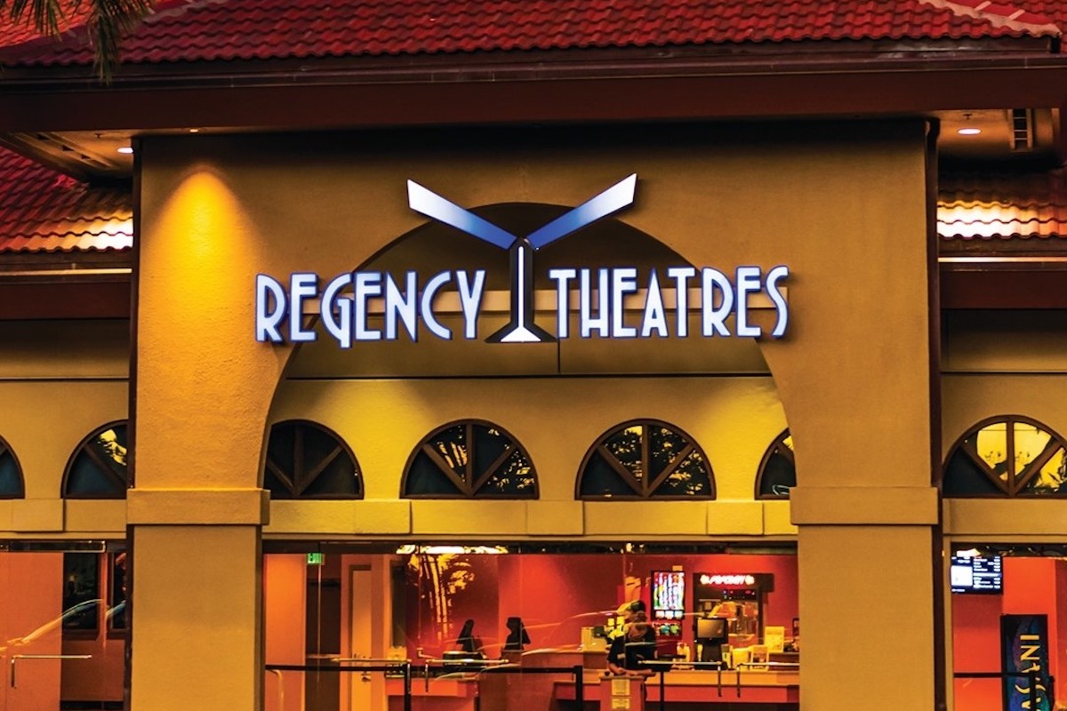A building with the sign "Regency Theaters" and an arched entrance.