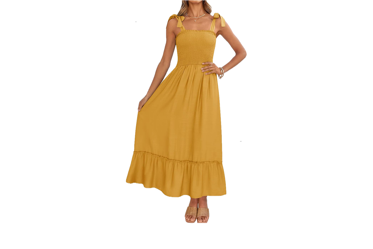 A woman wearing a long, yellow dress with a ruffled hem and tie straps.