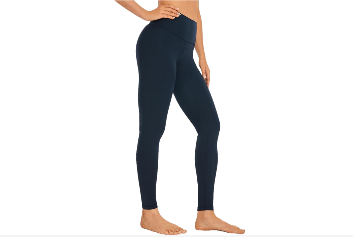 This image features the lower bottom of a woman, facing to the right, wearing a cropped style pair of yoga pants in a blue.
