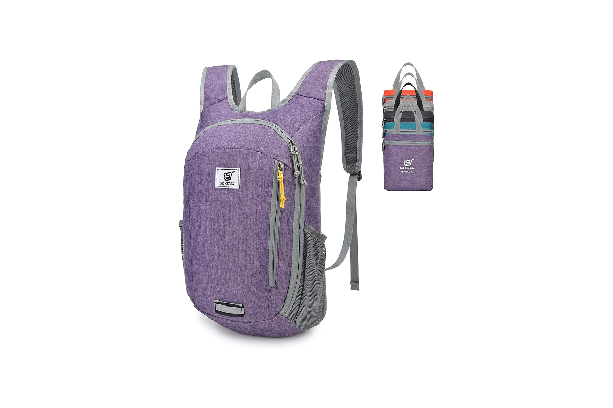 A light purple backpack with grey trim is displayed next to a group of bags showcasing other color options, including orange, green, black, blue, and purple.