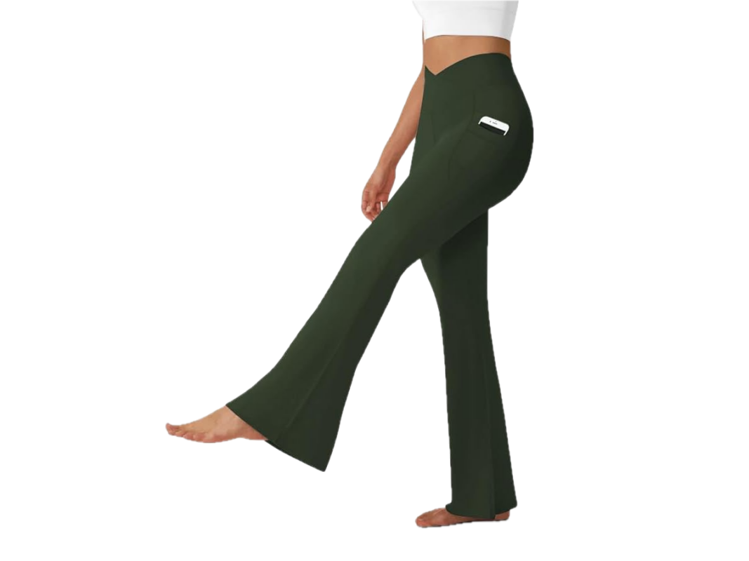This image features a woman's lower body wearing long, loose, green yoga pants.