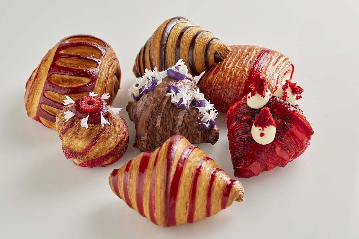 An array of various colorful croissants.