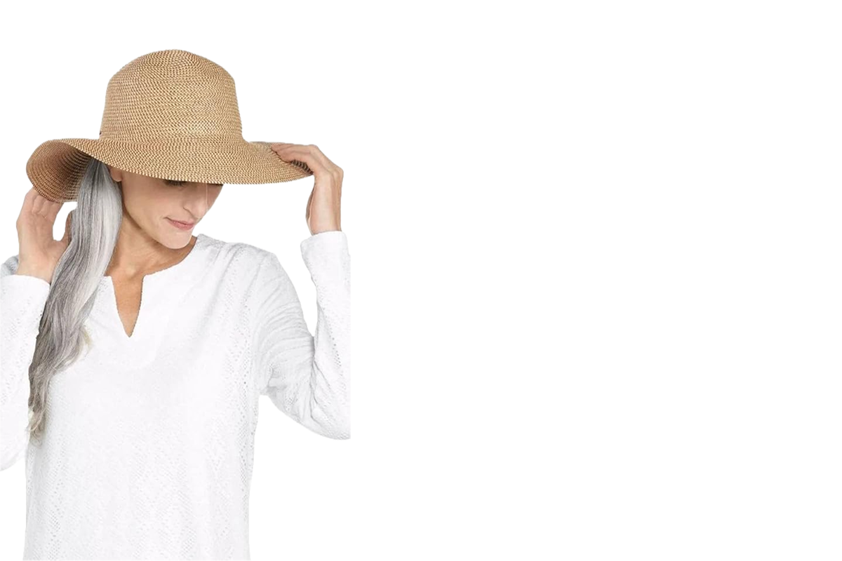 A woman wearing a white shirt and a tan wide brim hat.