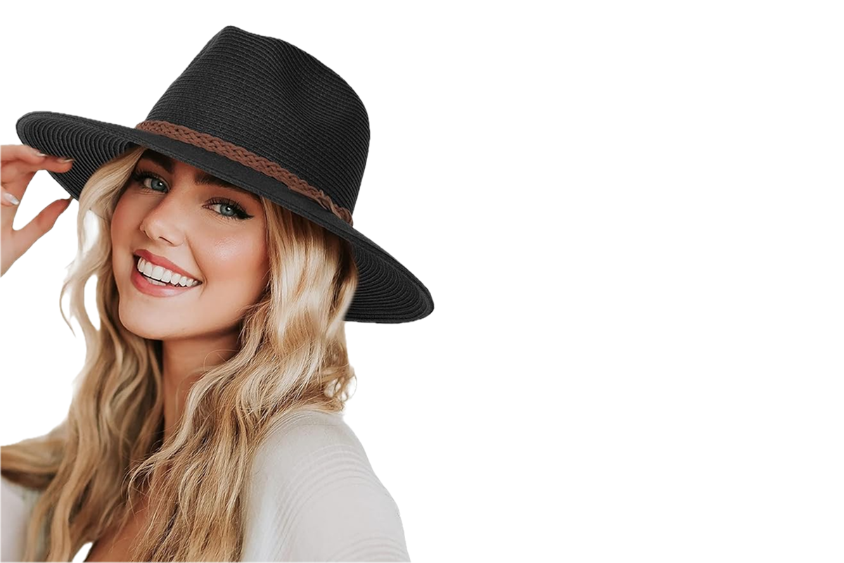 A woman wearing a black fedora style hat with a brown leather band.