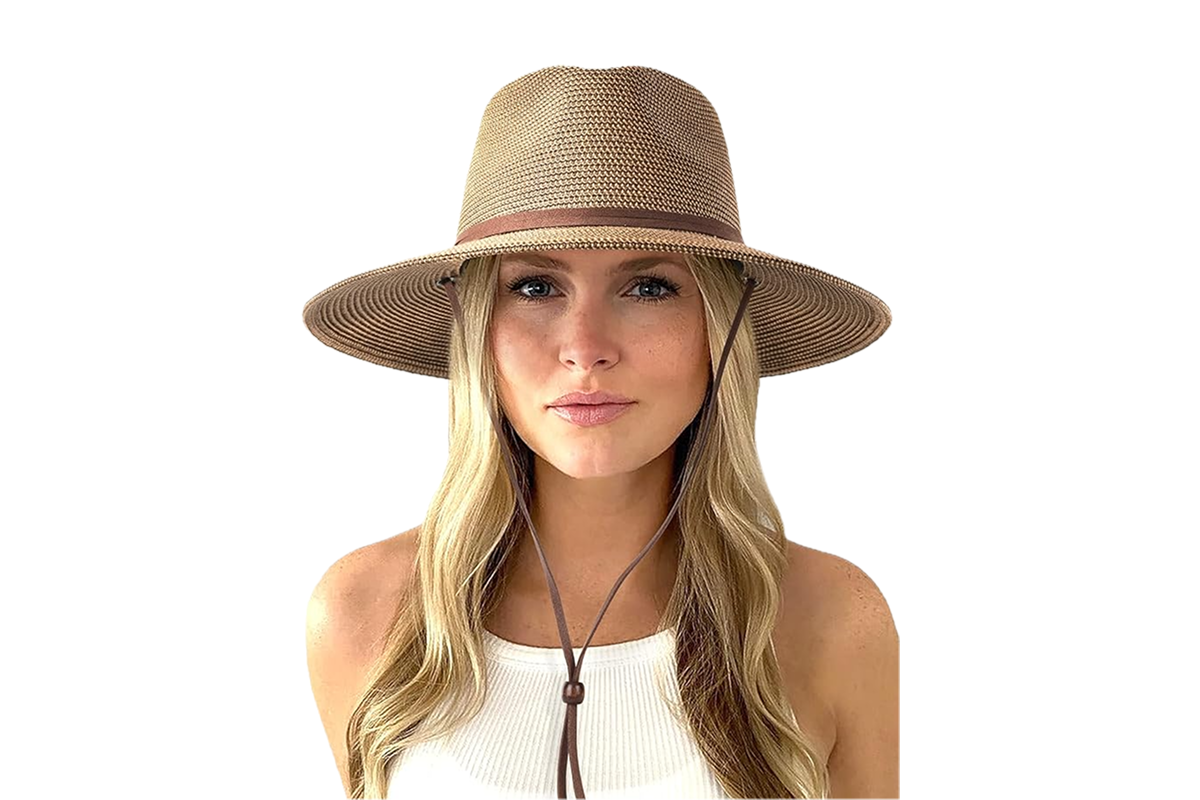 A woman in a white tank top wearing a tan/grey hat with a leather strap