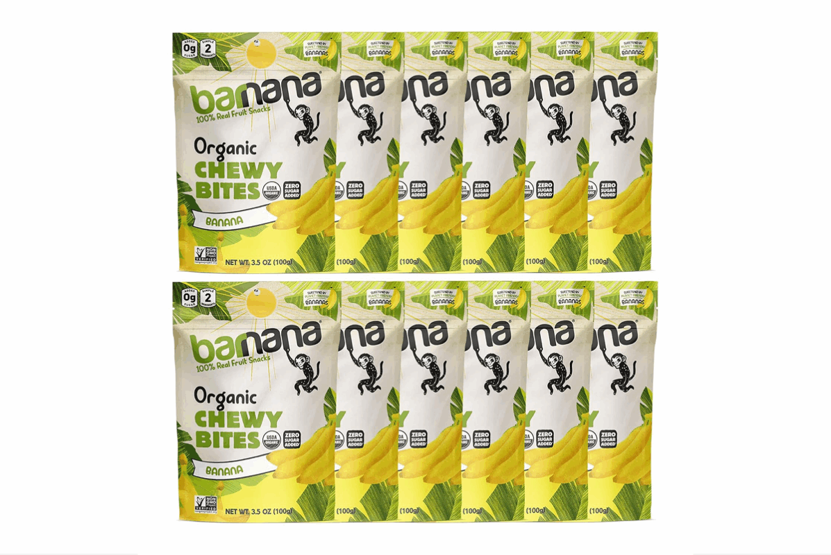 Four packages of banana-flavored organic chewy bites are depicted, perfect for road trip snacks. The packaging features an illustration of a smiling monkey and displays nutritional information like "Zero Sugar Added" and "Non-GMO." Each package weighs 3.5 oz (100g).