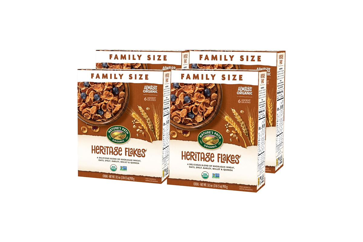 Four boxes of Nature's Path Organic Heritage Flakes cereal labeled "Family Size." Each box showcases the cereal with blueberries and promotes ingredients like Khorasan wheat, oats, spelt, barley, millet, and quinoa—perfect for healthy road trip snacks.