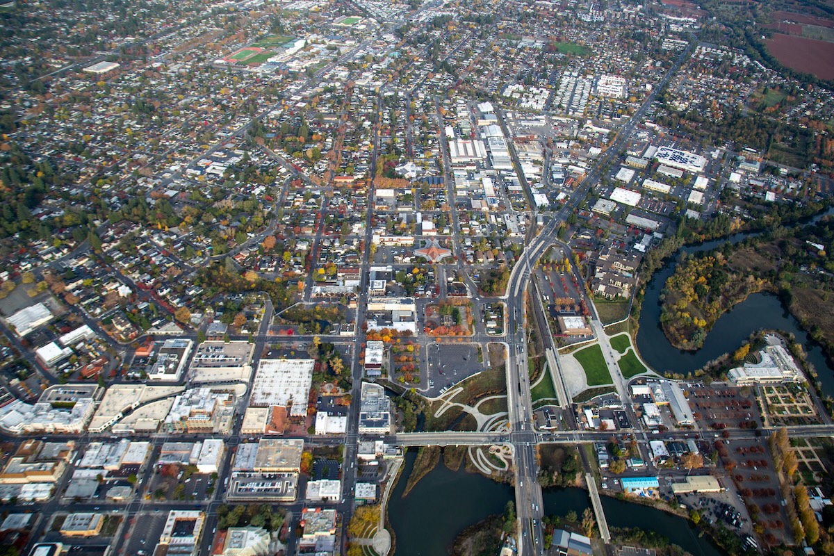 An aerial view of Downtown Napa, with lots of buildings and a river running through.