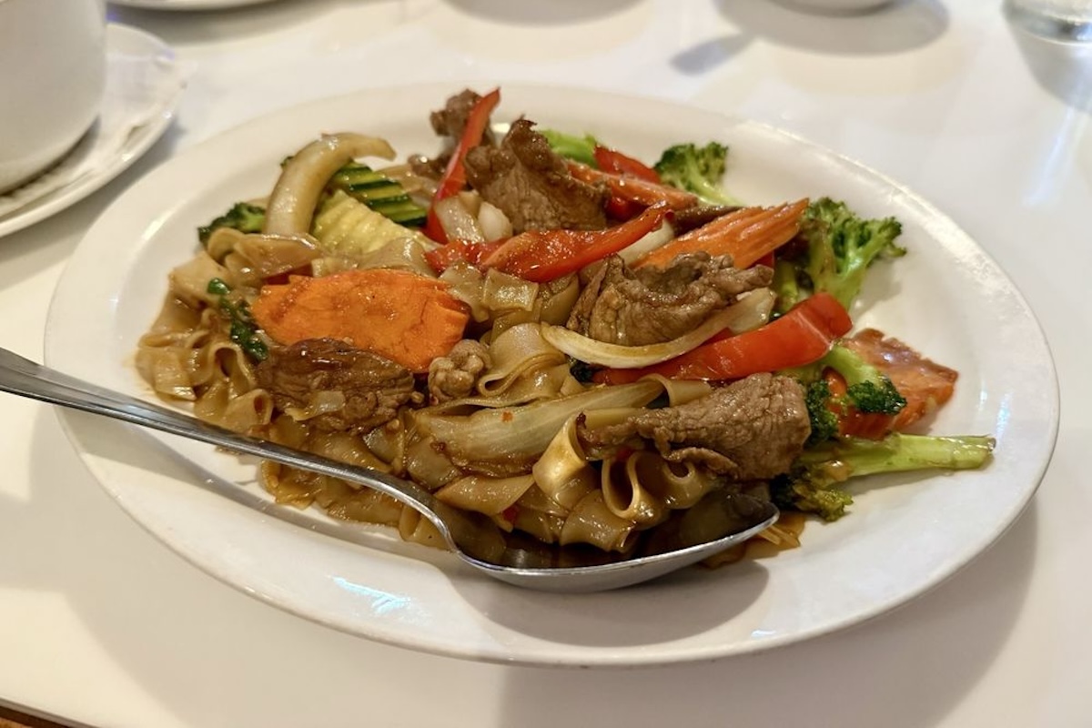 A plate with noodles and veggies.