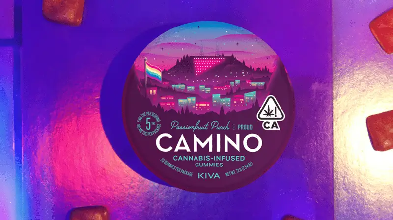 A round, colorful package of Camino Cannabis-Infused Gummies labeled Passionfruit Punch. The label is adorned with a stylized cityscape at dusk and a flag, perfect to celebrate San Francisco Pride all month long. The package includes symbols indicating THC content and compliance with California regulations.