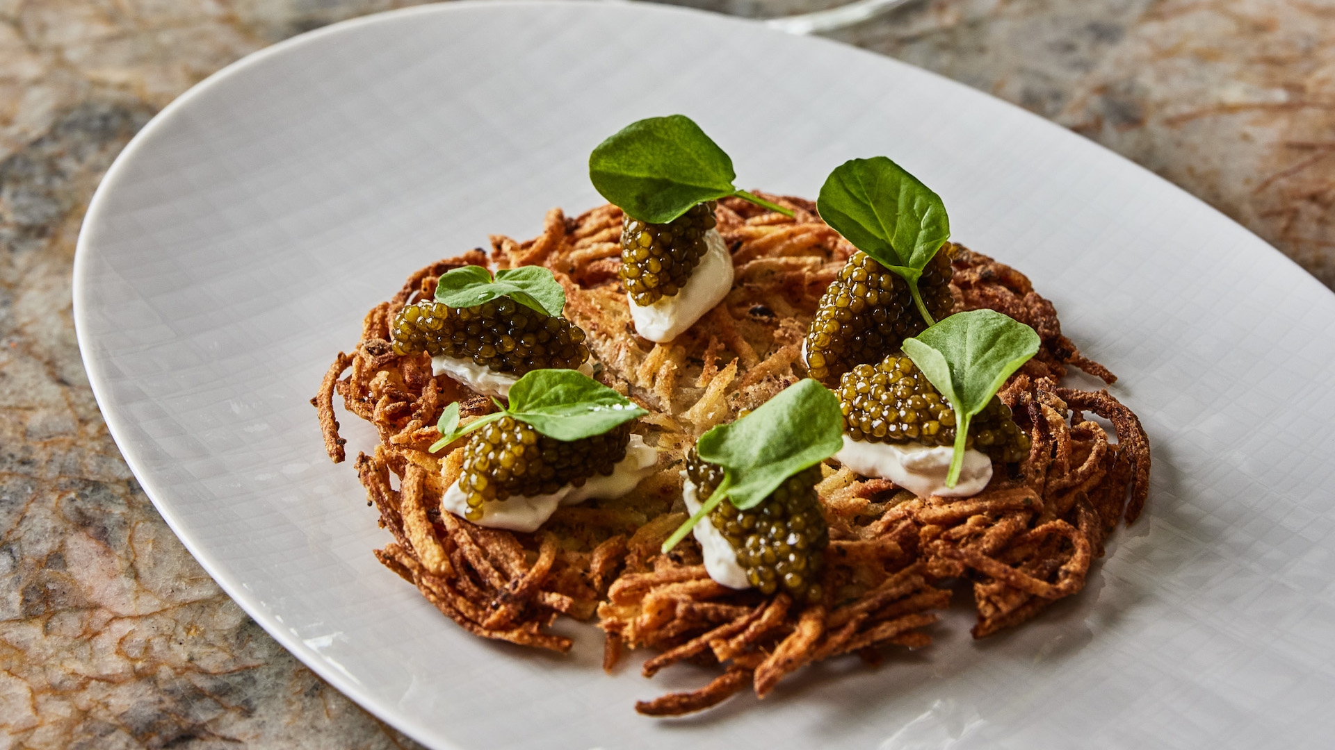 Caviar sits atop a bed of something crispy.