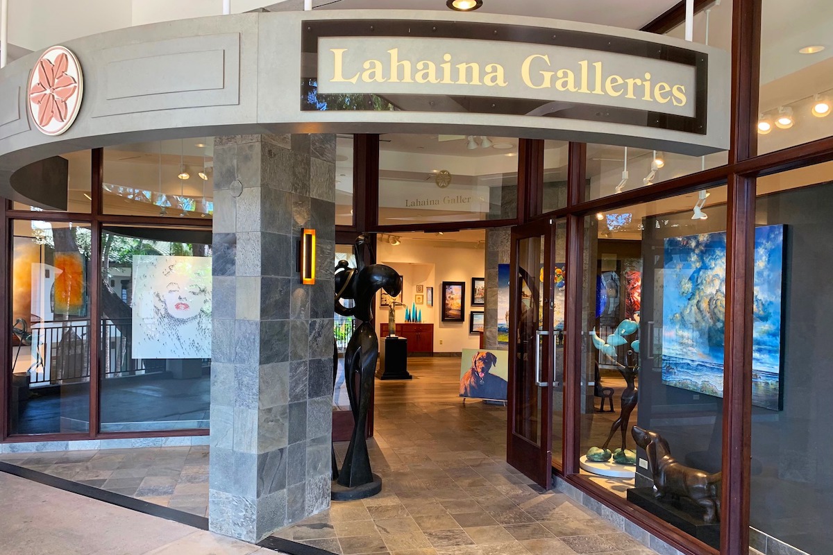 The entrance to Lahaina Galleries, with stone exterior, wide doors and lots of lighting.