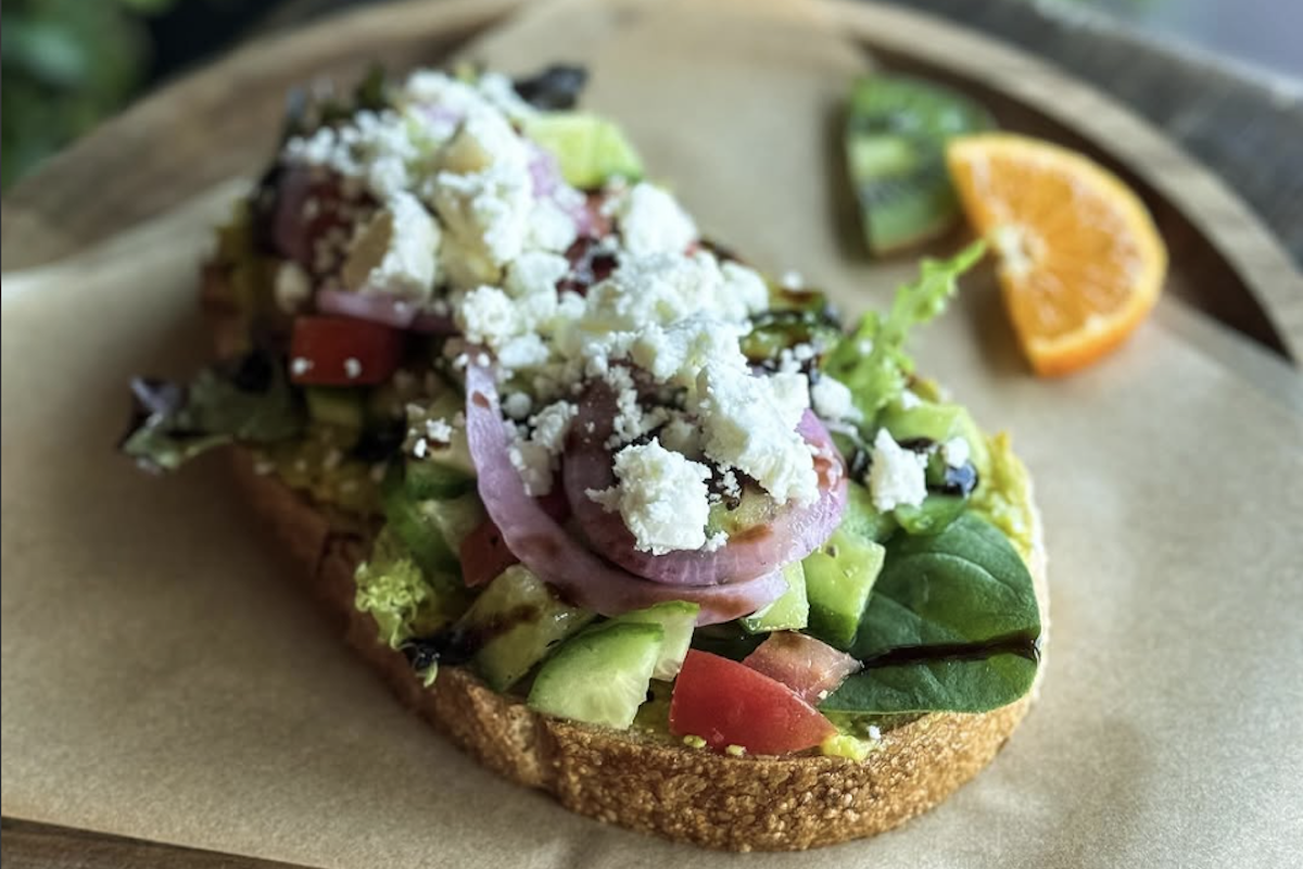 Avocado toast with cucumber, spinach, tomato, onions and feta.