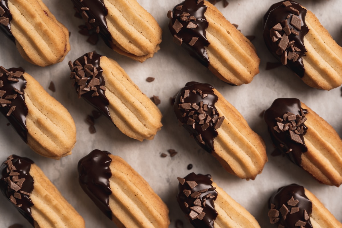 Oval-shaped cookies dipped in chocolate arranged in a pattern.