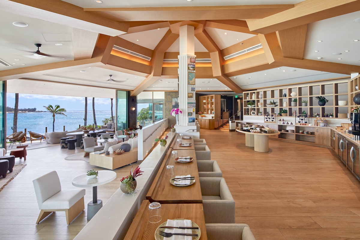 A shot of a large lounge and restaurant, with a long table down the center and a circular ceiling design.