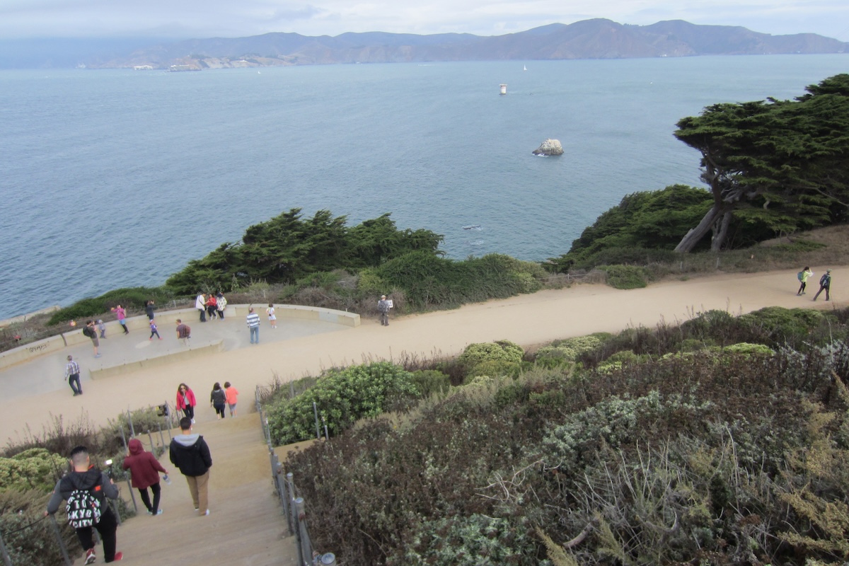 People wander around Lands End Park on the paths that overlook the bay.
