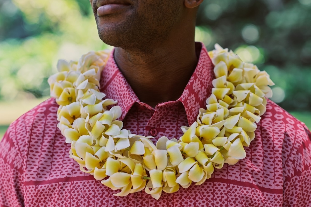 Man wear plumeria lei
