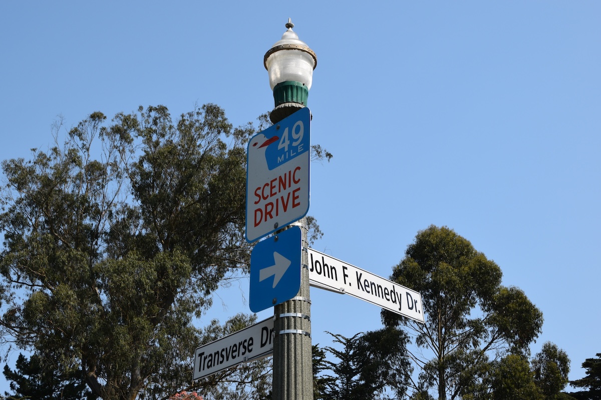 A sign post with the intersection for John F. Kennedy Drive and Transverse Dr.