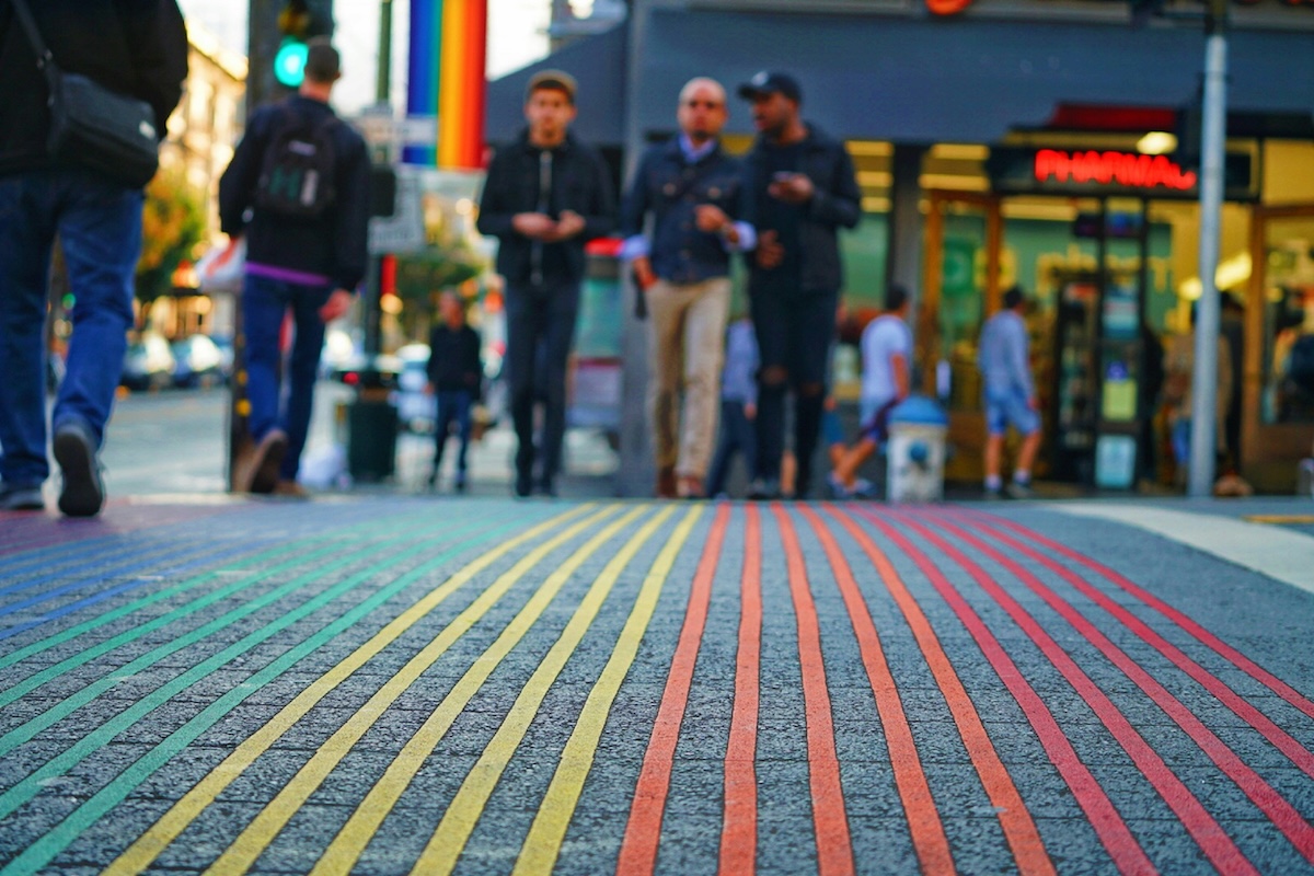 People walk across rainbow crosswalk in San Francisco's Castro District