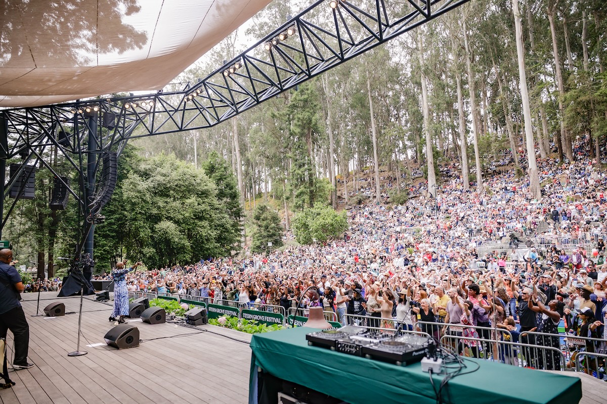 Musician playing to a crowd in a forest at Stern Grove Festival
