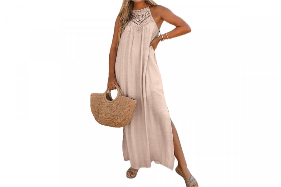 A woman wearing a tan, floor length, halter style dress.