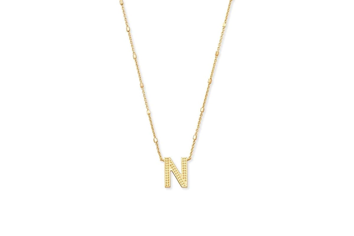 This image features a gold chain necklace with the letter N pendant